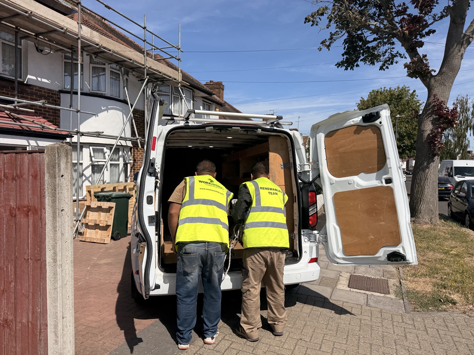 WorkWork team preparing equipment at a residential installation